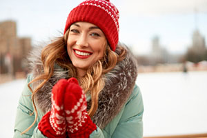 Woman With Gloves and a Hat Smiling Outside